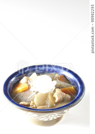 Hot pork offal stew with carrots, konjac, burdock and radish shot against a white background Hot pork offal stew with carrots, konjac, burdock and radish shot against a white background 98982293