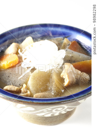 Hot pork offal stew with carrots, konjac, burdock and radish shot against a white background 98982298