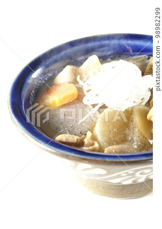 Hot pork offal stew with carrots, konjac, burdock and radish shot against a white background 98982299