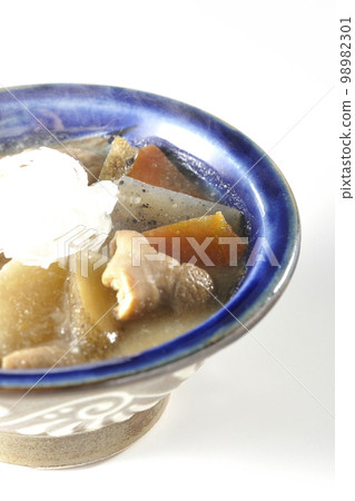 Hot pork offal stew with carrots, konjac, burdock and radish shot against a white background Hot pork offal stew with carrots, konjac, burdock and radish shot against a white background 98982301