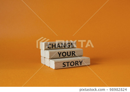 Change your story symbol. Concept word Change your story on wooden blocks. Beautiful orange background. Business and Change your story concept. Copy space Change your story symbol. Concept word Change your story on wooden blocks. Beautiful orange background. Business and Change your story concept. Copy space 98982824
