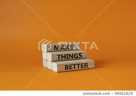 Make things better symbol. Concept word Make things better on wooden blocks. Beautiful orange background. Business and Make things better concept. Copy space 98982829