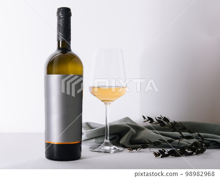 glass and bottle of wine on white 98982968