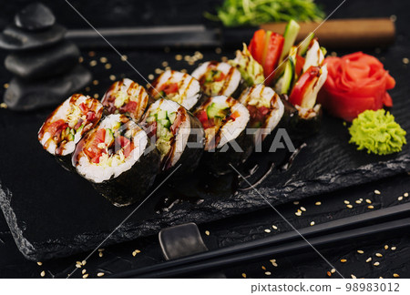 Vegetarian maki sushi rolls on black plate 98983012