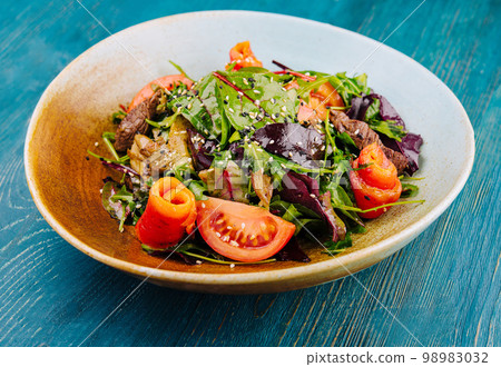 Warm salad with grilled meat and vegetables Warm salad with grilled meat and vegetables 98983032