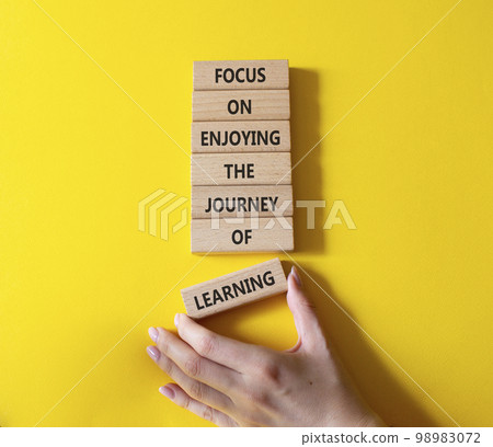 Learning symbol. Wooden blocks with words Focus on enjoying the journey of learning. Businessman hand. Beautiful yellow background. Business and Start and Learning concept. Copy space. Learning symbol. Wooden blocks with words Focus on enjoying the journey of learning. Businessman hand. Beautiful yellow background. Business and Start and Learning concept. Copy space. 98983072