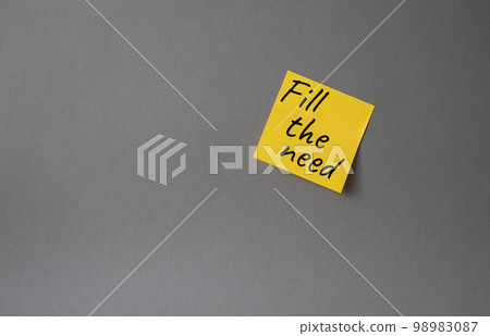 Fill the need symbol. Concept word Fill the need on steaky orange note. Beautiful grey background. Business and Fill the need concept. Copy space 98983087