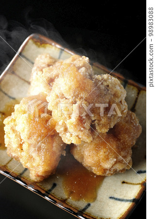 A bird's-eye view of hot chicken Tatsuta-age with grated ponzu sauce on a black background 98983088