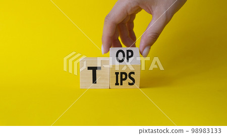 Top Tips symbol. Businessman hand Turnes cubes with words Top Tips. Beautiful yellow background. Business and Top Tips concept. Copy space Top Tips symbol. Businessman hand Turnes cubes with words Top Tips. Beautiful yellow background. Business and Top Tips concept. Copy space 98983133
