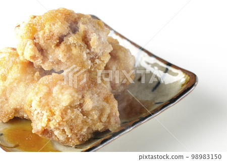 Hot chicken Tatsuta-age with grated radish and ponzu sauce photographed against a white background 98983150