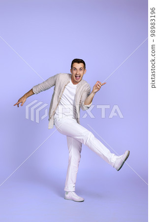 happy funny young man in casual shirt posing happy funny young man in casual shirt posing 98983196