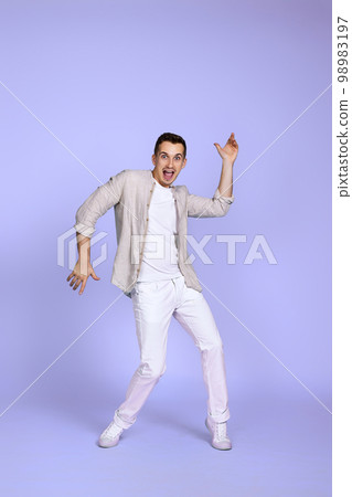 happy funny young man in casual shirt posing happy funny young man in casual shirt posing 98983197