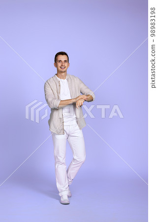 man in casual shirt posing on purple background. man in casual shirt posing on purple background. 98983198