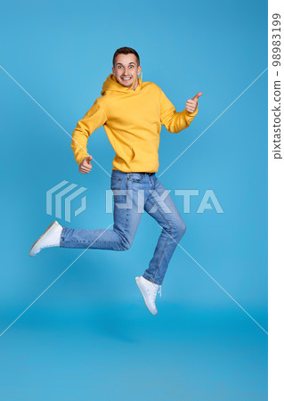 young happy man in casual clothes jumping young happy man in casual clothes jumping 98983199