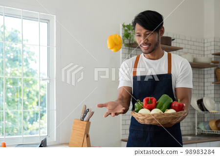 Men in the kitchen preparing materials ready to cook Men in the kitchen preparing materials ready to cook 98983284