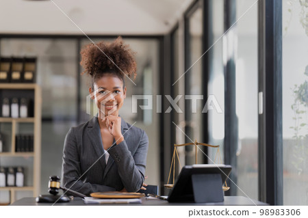 Female lawyer sitting at workplace in office 98983306