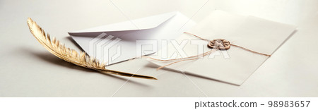 Golden pen and stamped envelope Golden pen and stamped envelope 98983657