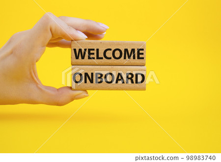 Welcome onboard symbol. Concept words Welcome onboard on wooden blocks. Beautiful yellow background. Businessman hand. Business and Welcome onboard concept. Copy space. Welcome onboard symbol. Concept words Welcome onboard on wooden blocks. Beautiful yellow background. Businessman hand. Business and Welcome onboard concept. Copy space. 98983740