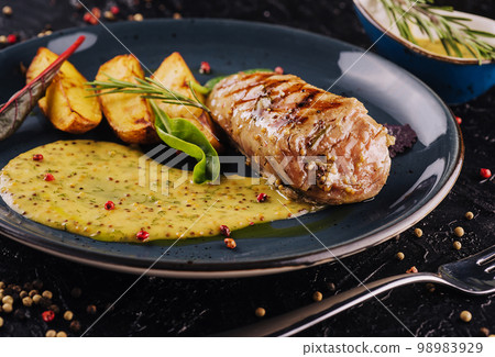 Slices of fried potatoes with chicken steak Slices of fried potatoes with chicken steak 98983929