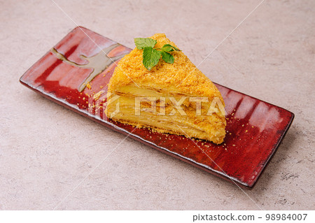 piece of Napoleon Cake on red plate 98984007
