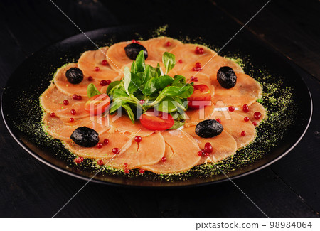 The tartare or carpaccio salmon salad 98984064