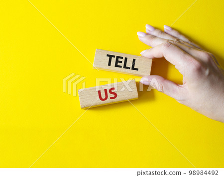 Tell us symbol. Concept words Tell us on wooden blocks. Beautiful yellow background. Businessman hand. Business and Tell us concept. Copy space. Tell us symbol. Concept words Tell us on wooden blocks. Beautiful yellow background. Businessman hand. Business and Tell us concept. Copy space. 98984492