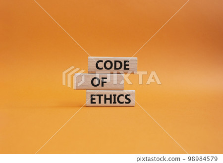 Code of ethics symbol. Concept words Code of ethics on wooden blocks. Beautiful orange background. Business and Code of ethics concept. Copy space. Code of ethics symbol. Concept words Code of ethics on wooden blocks. Beautiful orange background. Business and Code of ethics concept. Copy space. 98984579