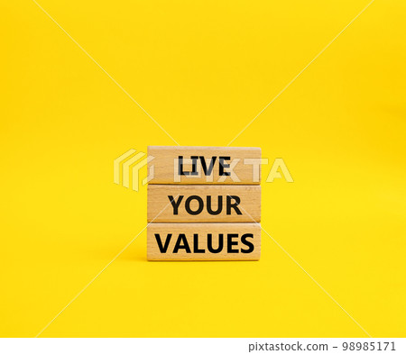 Live your values symbol. Concept words 'Live your values' on wooden blocks. Beautiful yellow background. Business and Live your values concept. Copy space. 98985171