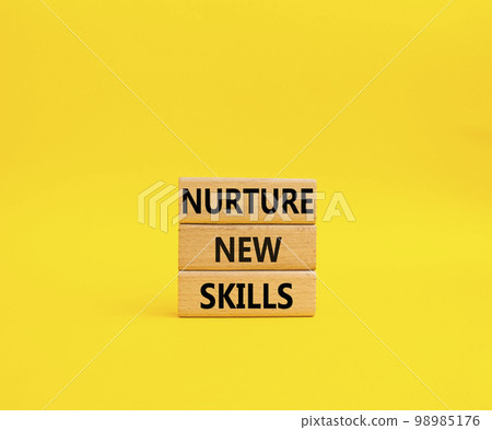 Nurture new skills symbol. Concept words Nurture new skills on wooden blocks. Beautiful yellow background. Business and Nurture new skills concept. Copy space Nurture new skills symbol. Concept words Nurture new skills on wooden blocks. Beautiful yellow background. Business and Nurture new skills concept. Copy space 98985176