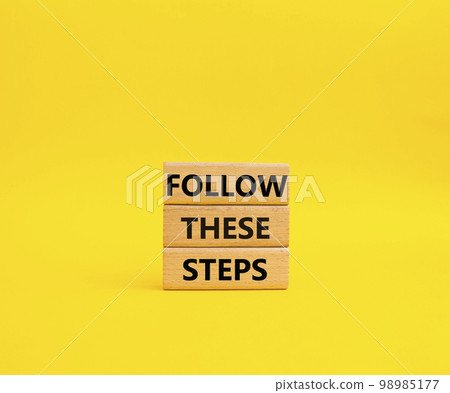 Follow these steps symbol. Wooden blocks with words Follow these steps. Beautiful yellow background. Business and Follow these steps concept. Copy space. Follow these steps symbol. Wooden blocks with words Follow these steps. Beautiful yellow background. Business and Follow these steps concept. Copy space. 98985177