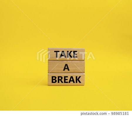 Take a break symbol. Concept words 'Take a break' on wooden blocks. Beautiful yellow background. Business and Take a break concept. Copy space. Take a break symbol. Concept words 'Take a break' on wooden blocks. Beautiful yellow background. Business and Take a break concept. Copy space. 98985181