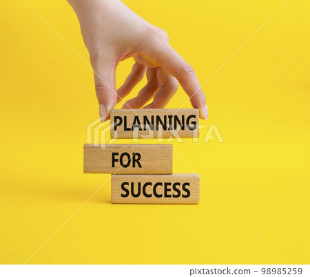 Planning for success symbol. Concept words Planning for success on wooden blocks. Businessman hand. Beautiful yellow background. Business and Planning for success concept. Copy space 98985259