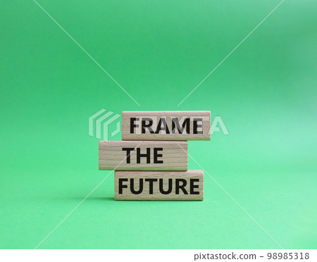Frame the future symbol. Wooden blocks with words Frame the future. Beautiful green background. Business and Frame the future concept. Copy space. 98985318