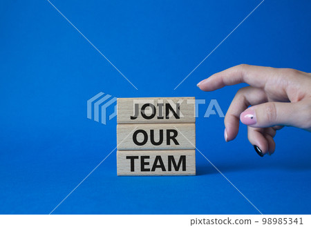 Join our team symbol. Wooden blocks with words Join our team. Beautiful blue background. Businessman hand. Business and Join our team concept. Copy space. Join our team symbol. Wooden blocks with words Join our team. Beautiful blue background. Businessman hand. Business and Join our team concept. Copy space. 98985341