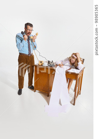 Businessman making ideas, giving information and woman, personal assistant making notes over grey background. Concept of business, employment, work 98985365