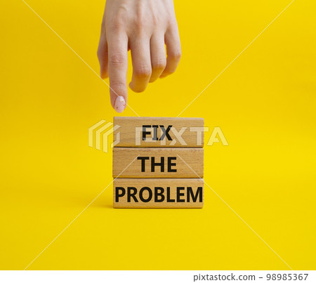 Fix the problem symbol. Wooden blocks with words Fix the problem. Beautiful yellow background. Businessman hand. Business and Fix the problem concept. Copy space. Fix the problem symbol. Wooden blocks with words Fix the problem. Beautiful yellow background. Businessman hand. Business and Fix the problem concept. Copy space. 98985367