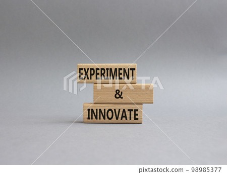 Experiment and innovate symbol. Concept words Experiment and innovate on wooden blocks. Beautiful grey background. Business and Experiment and innovate concept. Copy space. 98985377