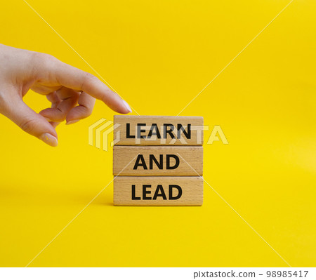 Learn and lead symbol. Concept words 'Learn and lead' on wooden blocks. Beautiful yellow background. Businessman hand. Business and Learn and lead concept. Copy space. Learn and lead symbol. Concept words 'Learn and lead' on wooden blocks. Beautiful yellow background. Businessman hand. Business and Learn and lead concept. Copy space. 98985417