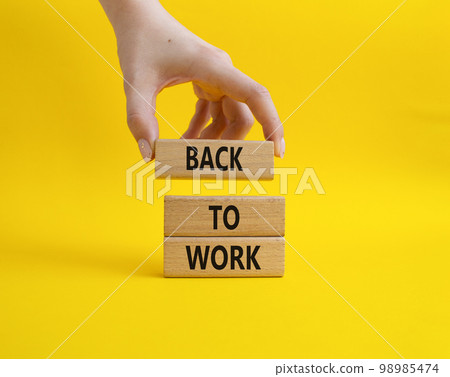 Back to Work symbol. Wooden blocks with words Back to Work. Beautiful yellow background. Businessman hand. Business and Back to Work. Copy space. Back to Work symbol. Wooden blocks with words Back to Work. Beautiful yellow background. Businessman hand. Business and Back to Work. Copy space. 98985474