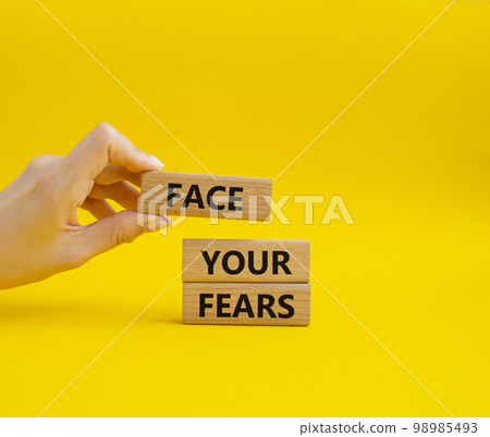 Face your Fears symbol. Wooden blocks with words Face your Fears. Beautiful yellow background. Businessman hand. Business and Face your Fears. Copy space. Face your Fears symbol. Wooden blocks with words Face your Fears. Beautiful yellow background. Businessman hand. Business and Face your Fears. Copy space. 98985493