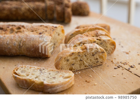 fresh loaf of bread on wooden board 98985750