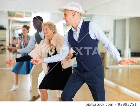 Jazz dancers standing in row and flicking with fingers 98985751
