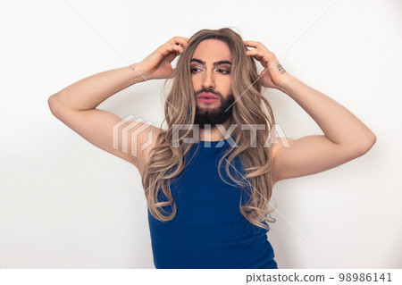 Travesty man fixing his fake long hair 98986141