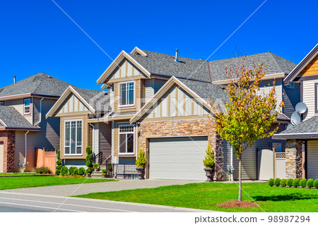 Suburban family house with green lawn in front Suburban family house with green lawn in front 98987294