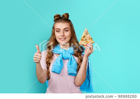 woman eating delicious pizza slice and showing ok gesture 98988200