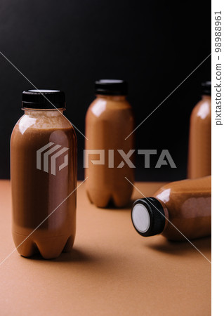 chocolate smoothies milkshake in bottles on brown background 98988961