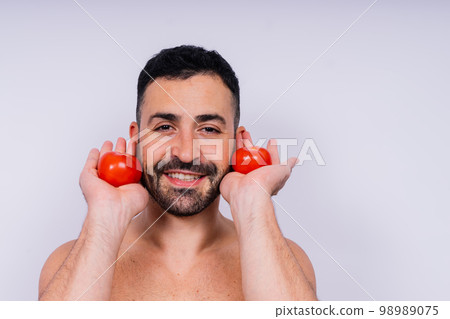 Full isolated studio picture from a young naked man with underwear and tomato 98989075