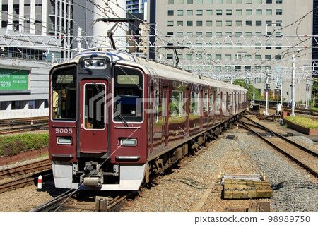 Hankyu Railway Series 9000 train running near Umeda Station in Osaka 98989750