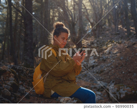 caucasian woman enjoys being in nature, 98990035
