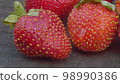 Ripe strawberries on a wooden board 98990386